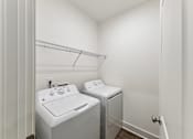 Thumbnail 21 of 26 - a washer and dryer in a laundry room with a sink and a closet