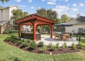 Thumbnail 34 of 47 - a pergola with a table and chairs in a backyard