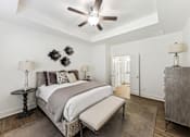 Thumbnail 12 of 26 - a bedroom with a bed and a ceiling fan