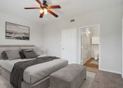 Thumbnail 4 of 25 - a bedroom with a large bed and a ceiling fan