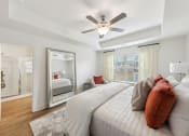 Thumbnail 16 of 25 - a bedroom with a large bed and a ceiling fan