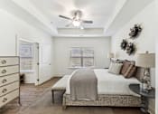 Thumbnail 13 of 26 - a bedroom with a bed and a ceiling fan