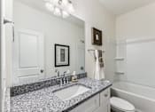 Thumbnail 19 of 26 - a bathroom with a sink and a mirror and a toilet