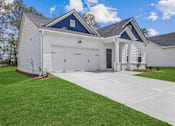 Thumbnail 26 of 26 - a white house with a driveway and a garage door