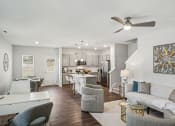 Thumbnail 11 of 25 - an open living room and kitchen with a ceiling fan