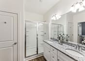 Thumbnail 16 of 26 - a bathroom with two sinks and a shower