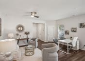 Thumbnail 15 of 25 - a living room with a dining room table and chairs and a ceiling fan