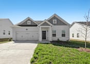 Thumbnail 1 of 26 - a white house with a driveway and a garage door