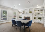 Thumbnail 13 of 25 - a dining room with a table and chairs in front of a fireplace