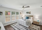 Thumbnail 17 of 25 - a bedroom with a bed and a ceiling fan