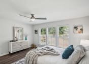Thumbnail 18 of 25 - a bedroom with a large bed and a ceiling fan