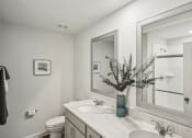 Thumbnail 19 of 25 - a white bathroom with a sink and a mirror