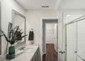 Thumbnail 20 of 25 - a bathroom with a sink and a shower and a mirror