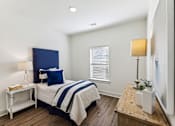 Thumbnail 17 of 26 - a bedroom with a bed and a dresser and a window