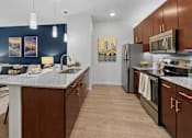 Thumbnail 3 of 47 - A kitchen with brown cabinets and a white countertop.