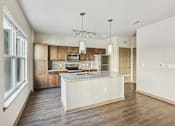 Thumbnail 30 of 39 - A modern kitchen with wooden cabinets and a central island.