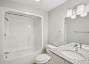 Thumbnail 23 of 27 - A white bathroom with a sink, toilet, and bathtub.