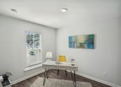 Thumbnail 21 of 25 - an office with white walls and a window with white blinds and a table with