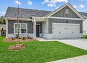 Thumbnail 24 of 26 - a white and gray house with a garage and a lawn