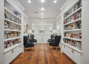 Thumbnail 17 of 25 - a living room filled with bookshelves and chairs