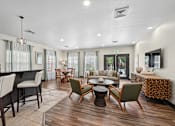Thumbnail 6 of 25 - A well-lit, modern living room with a variety of seating options and a dining table.