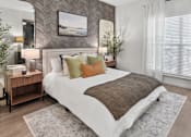 Thumbnail 6 of 47 - A bedroom with a large bed and a painting on the wall.