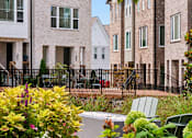 Thumbnail 147 of 149 - A row of houses with a black fence in front.