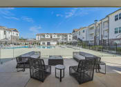 Thumbnail 4 of 36 - an outdoor patio with tables and chairs next to a pool