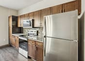 Thumbnail 29 of 39 - A modern kitchen with a stainless steel refrigerator.