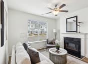 Thumbnail 9 of 25 - a living room with a couch and a fireplace