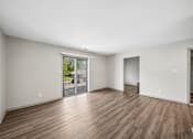 Thumbnail 3 of 35 - A room with wooden floors and white walls.