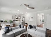 Thumbnail 1 of 25 - an open living room and kitchen with couches and a table