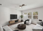 Thumbnail 3 of 25 - a living room with a couch and a coffee table