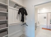Thumbnail 13 of 29 - A black robe is hanging on a white wall next to a staircase.