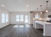 Thumbnail 27 of 29 - A spacious kitchen with a large island and modern appliances.