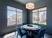 Thumbnail 23 of 35 - A dining room with a round table and chairs.