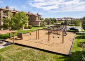 Thumbnail 8 of 32 - a playground in the middle of a park with houses in the background