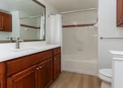 Thumbnail 16 of 36 - A bathroom with a white toilet and a white sink.