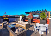 Thumbnail 26 of 34 - Luxury Apartments for Rent in Seattle, WA- Union Bay- Rooftop Lounge Multiple Seating Areas with City View and Landscaping