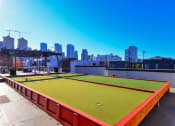 Thumbnail 28 of 34 - a soccer field on the roof of a building with a cityscape in the background