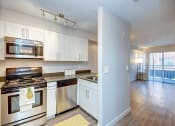 Thumbnail 13 of 34 - a kitchen with white cabinets and stainless steel appliances