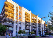 Thumbnail 33 of 34 - a row of apartment buildings with a blue sky in the background