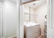 Thumbnail 6 of 34 - a small laundry room with a washer and dryer