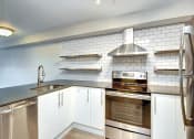 Thumbnail 12 of 34 - a kitchen with a stove top oven next to a sink