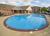 Thumbnail 55 of 65 - A large outdoor swimming pool with a brown border.