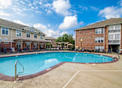 Thumbnail 41 of 65 - A swimming pool surrounded by a brick building.