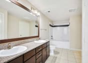 Thumbnail 32 of 48 - a bathroom with two sinks and a shower and a toilet