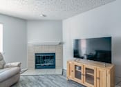 Thumbnail 33 of 41 - A modern living room with a fireplace and a flat screen TV.