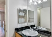 Thumbnail 36 of 41 - A bathroom with a sink and mirror.