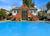 Thumbnail 1 of 41 - A house with a pool in front.